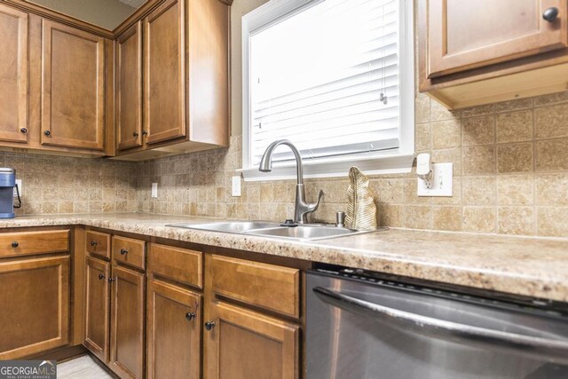 141 Back Cedar Ln, Warner Robins, GA 31093 - kitchen featuring a sink, backsplash, stainless steel dishwasher, and light countertops