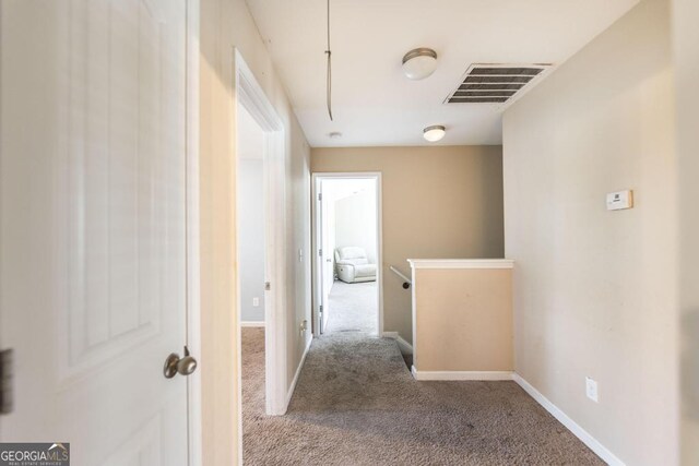 141 Back Cedar Ln, Warner Robins, GA 31093 - corridor with carpet flooring, an upstairs landing, visible vents, baseboards, and attic access
