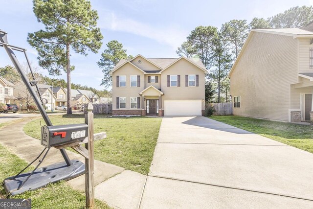 141 Back Cedar Ln, Warner Robins, GA 31093 - traditional home with an attached garage, brick siding, fence, driveway, and a front yard