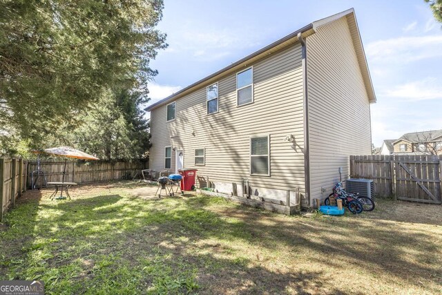 141 Back Cedar Ln, Warner Robins, GA 31093 - back of property featuring a yard and a fenced backyard
