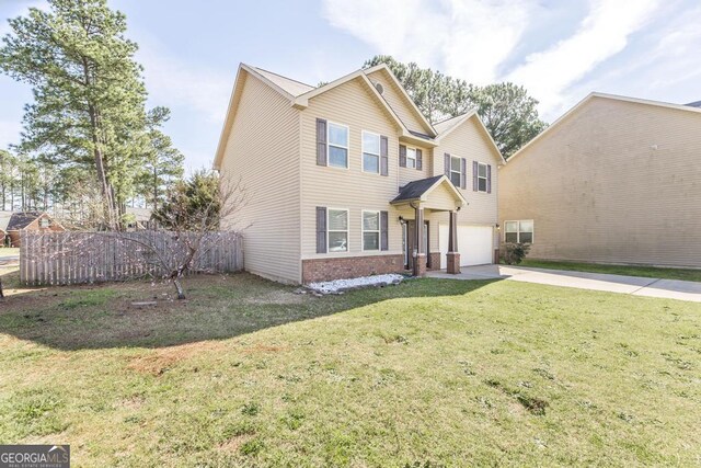 141 Back Cedar Ln, Warner Robins, GA 31093 - traditional-style home with an attached garage, brick siding, fence, driveway, and a front lawn