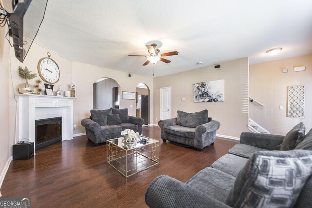 141 Back Cedar Ln, Warner Robins, GA 31093 - living area featuring baseboards, arched walkways, ceiling fan, wood finished floors, and a fireplace