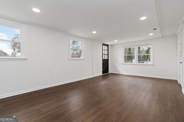 unfurnished living room with a healthy amount of sunlight, dark wood-style floors, and recessed lighting