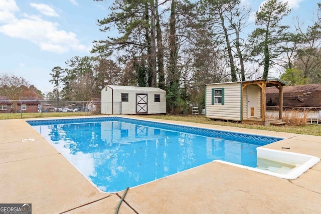 view of pool with a fenced in pool, an outbuilding, a shed, and fence