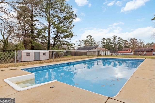 view of pool with a fenced in pool and fence
