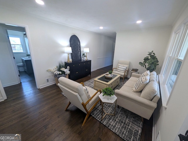 living area featuring crown molding, baseboards, dark wood-type flooring, visible vents, and recessed lighting