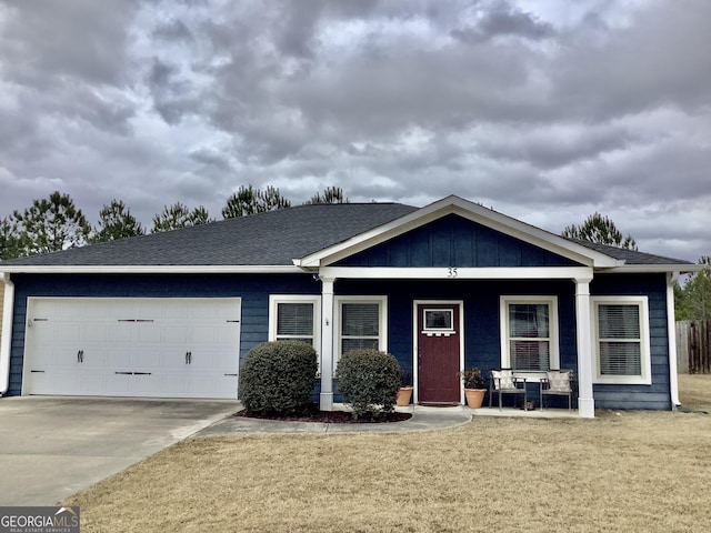 view of front of house featuring a garage, concrete driveway, covered porch, board and batten siding, and a front yard