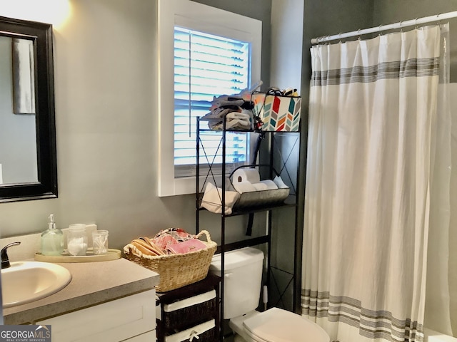 full bathroom with toilet, vanity, and a shower with curtain