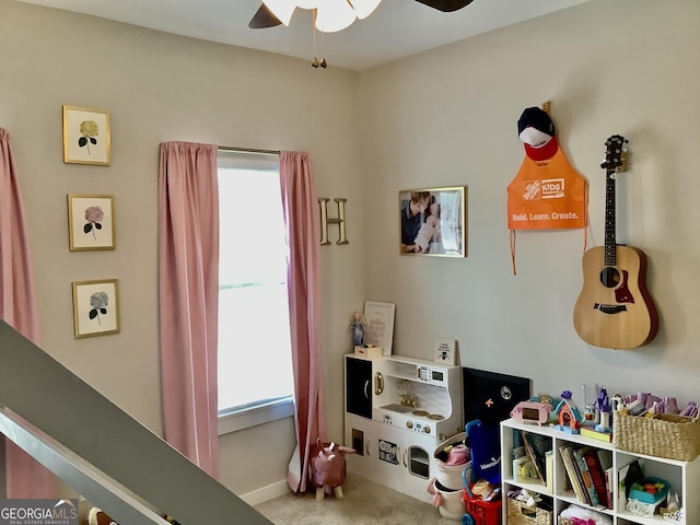 playroom featuring carpet floors, a ceiling fan, and baseboards