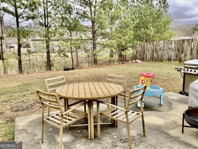 view of patio / terrace with fence, grilling area, and outdoor dining space