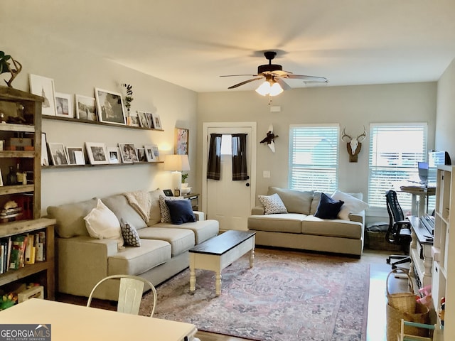 living area with a ceiling fan