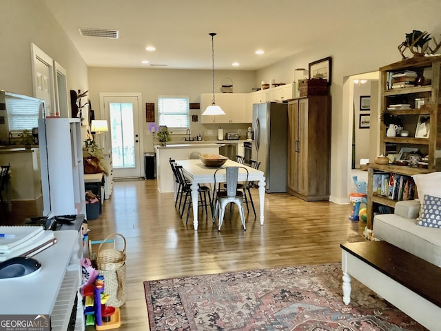 dining area with recessed lighting, visible vents, and light wood finished floors