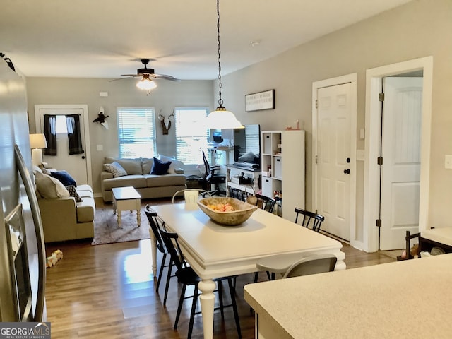 dining space with ceiling fan and wood finished floors