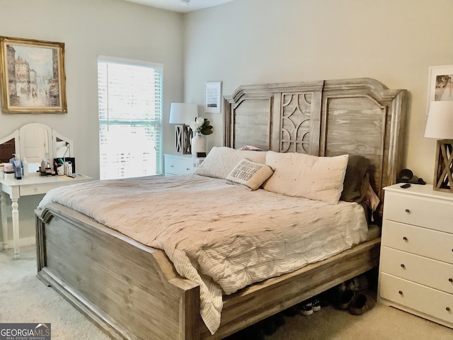 bedroom featuring light carpet