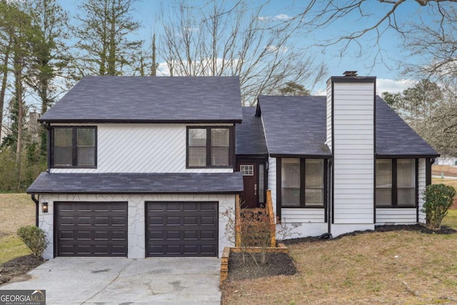 tri-level home featuring driveway, a garage, and a chimney