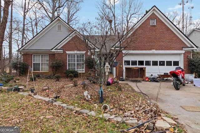 view of front of property with driveway, brick siding, and an attached garage