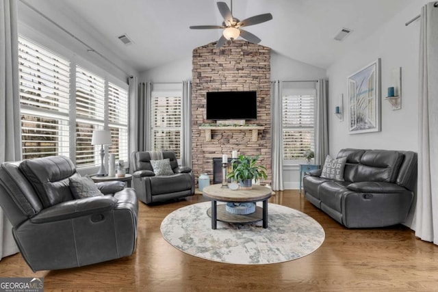 living area featuring a healthy amount of sunlight, visible vents, and ceiling fan