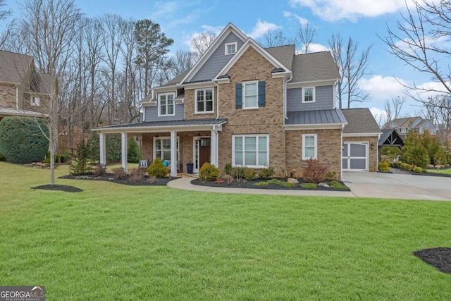 view of front of house with a front yard, a porch, metal roof, concrete driveway, and a standing seam roof