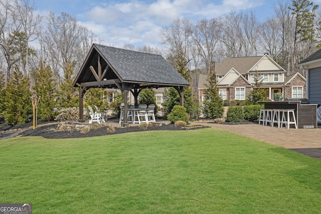 view of yard featuring a gazebo, a patio, and outdoor dry bar