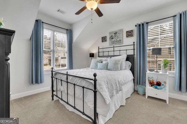 carpeted bedroom featuring visible vents, baseboards, a ceiling fan, and lofted ceiling