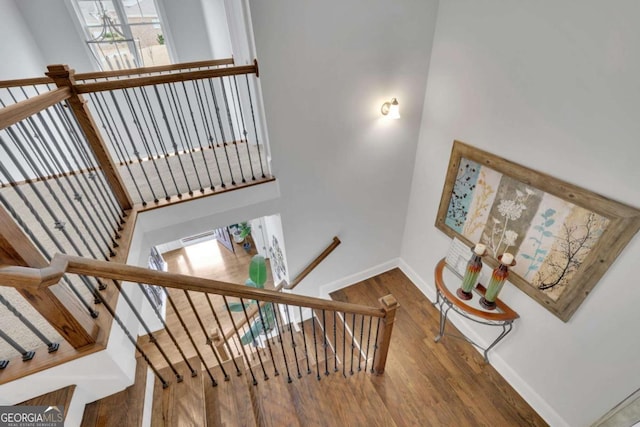 stairway featuring baseboards and wood finished floors