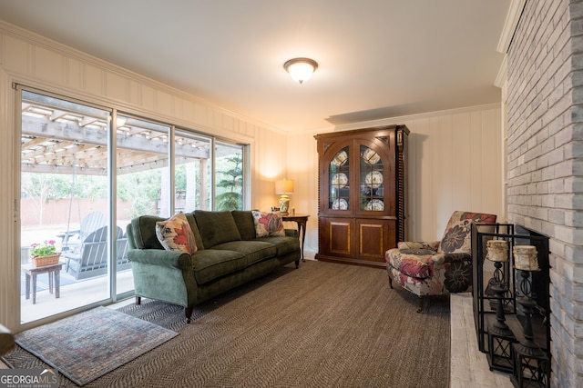 carpeted living area featuring a fireplace and crown molding