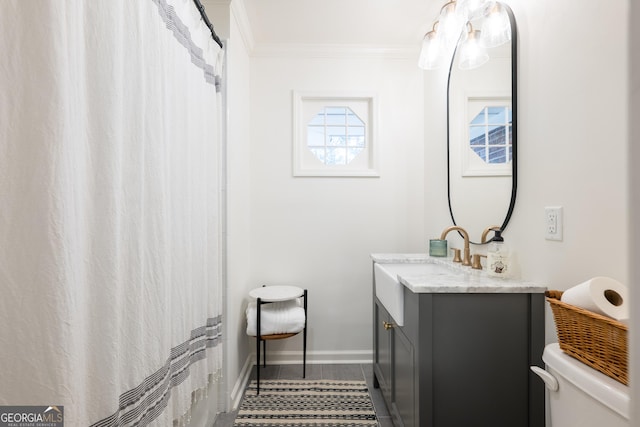 full bath with baseboards, toilet, tile patterned floors, crown molding, and vanity