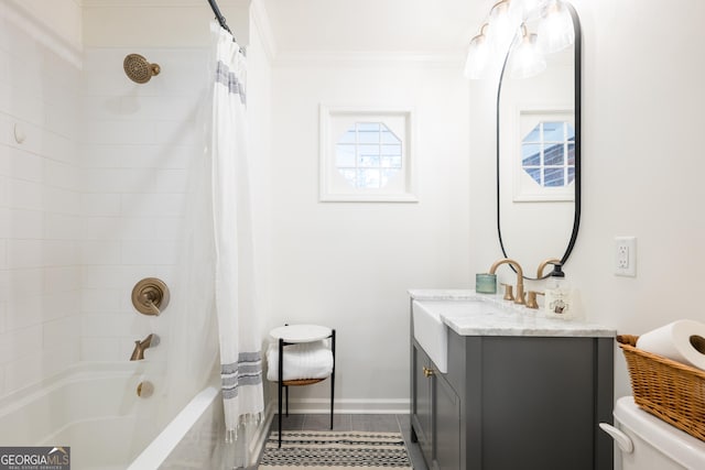 bathroom featuring crown molding, toilet, shower / bath combo with shower curtain, vanity, and baseboards