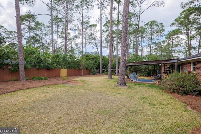 view of yard with fence and a patio