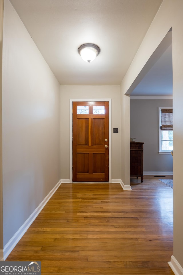 entryway featuring baseboards and wood finished floors