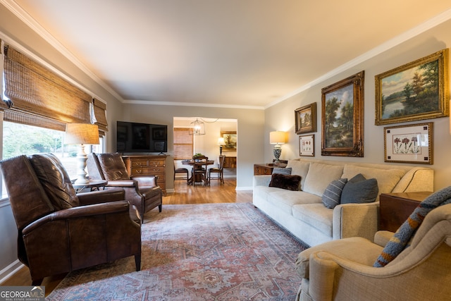 living room featuring crown molding, baseboards, and wood finished floors