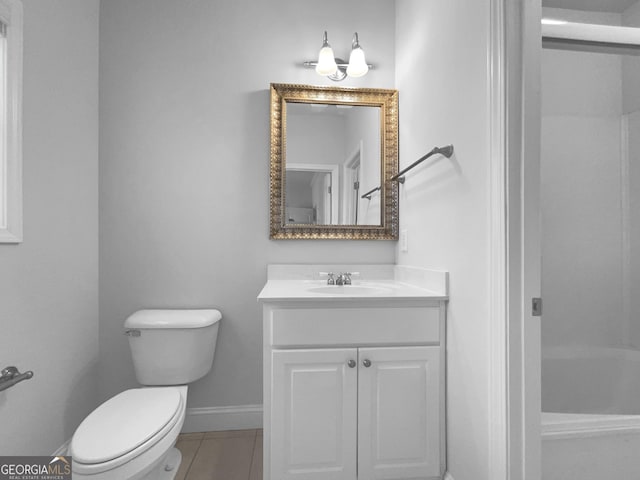 full bath featuring a tub to relax in, a shower, toilet, vanity, and baseboards