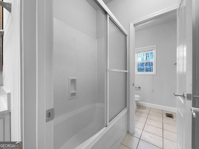 bathroom with tile patterned flooring, toilet, visible vents, baseboards, and combined bath / shower with glass door