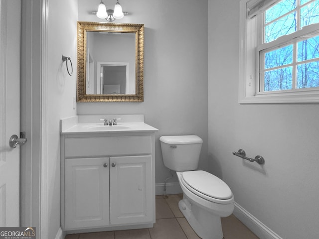 bathroom featuring baseboards, vanity, toilet, and tile patterned floors