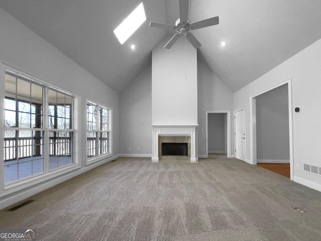 unfurnished living room featuring a high end fireplace, baseboards, visible vents, and carpet flooring