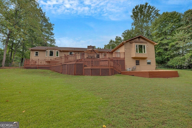 back of house with a yard and a deck