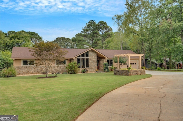 view of front of house featuring stone siding, a front yard, concrete driveway, and an attached garage