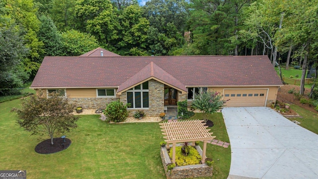 view of front of house featuring a garage, a front yard, stone siding, and driveway