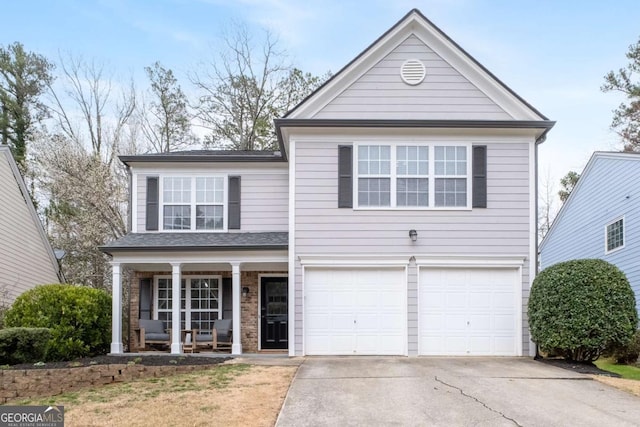 traditional-style house featuring an attached garage, a porch, and concrete driveway