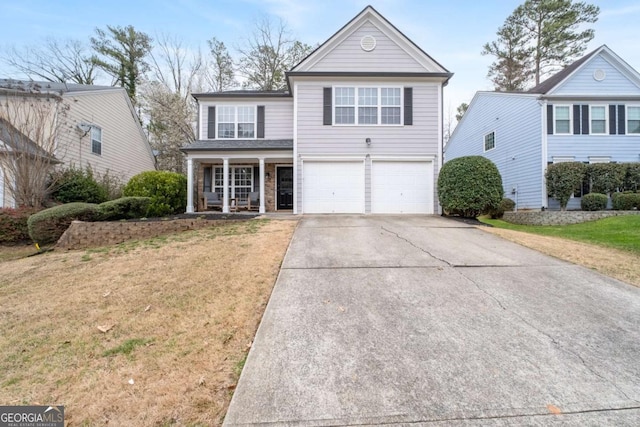 traditional home featuring a garage, concrete driveway, and a front lawn