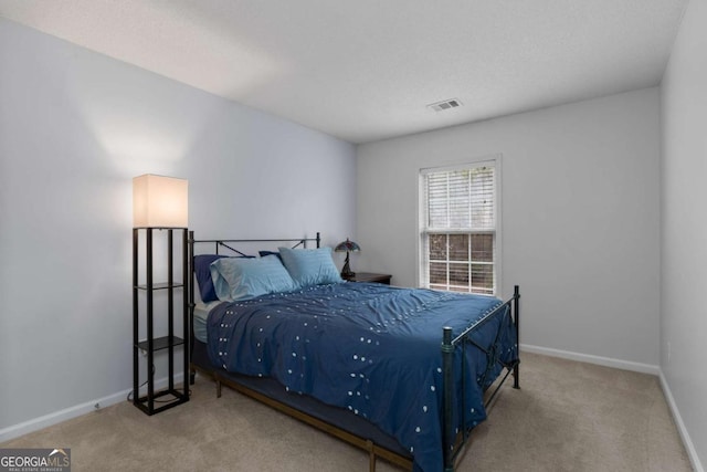 bedroom featuring carpet, visible vents, and baseboards