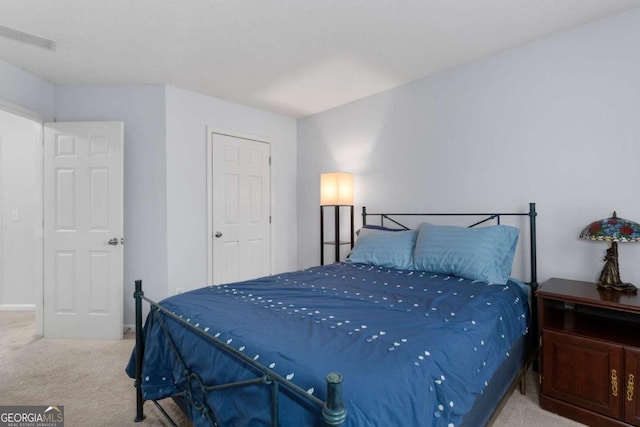 bedroom featuring carpet floors and visible vents