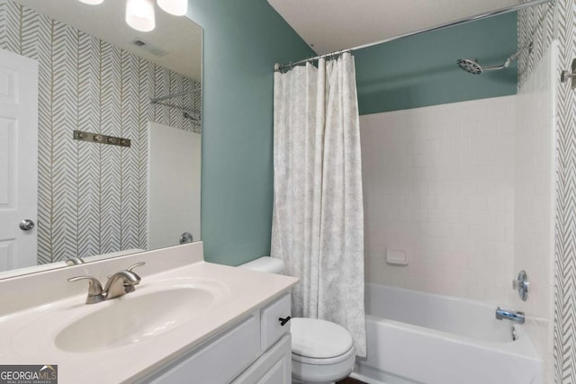 full bath with shower / tub combo, vanity, and toilet