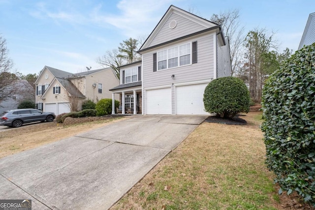 traditional home featuring concrete driveway and an attached garage