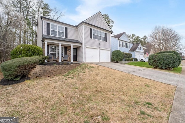 traditional home featuring driveway, a front lawn, a porch, and an attached garage