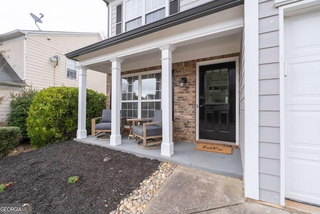 doorway to property featuring a garage and a porch