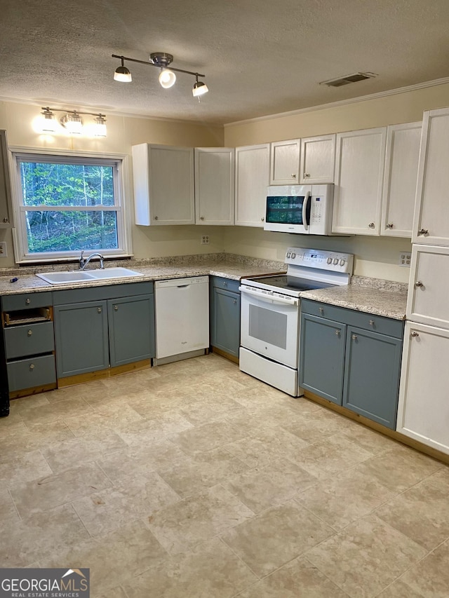 kitchen with a sink, white appliances, light countertops, a textured ceiling, and gray cabinetry