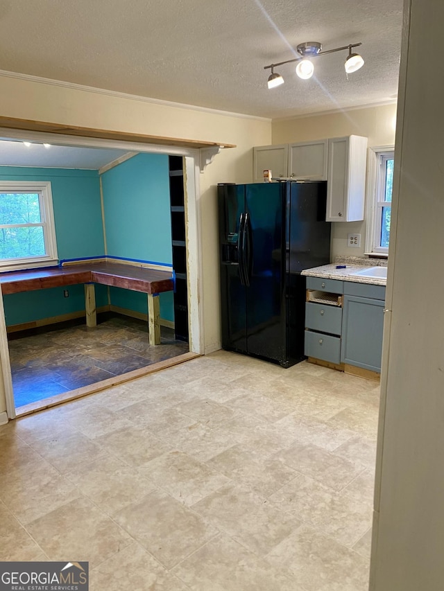 kitchen featuring a textured ceiling, gray cabinets, and black refrigerator with ice dispenser