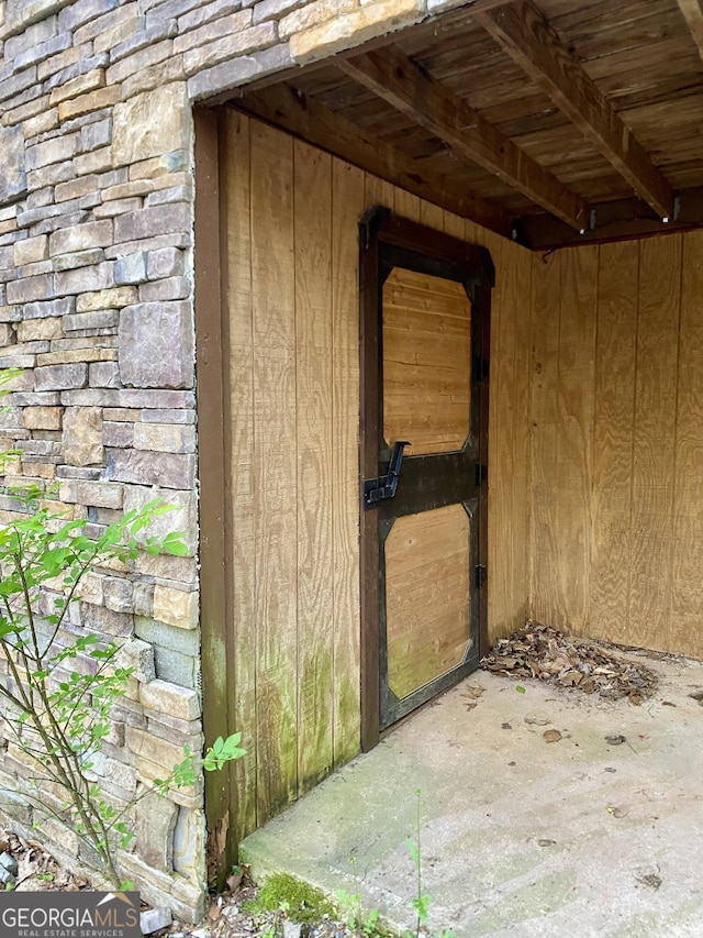 doorway to property featuring stone siding