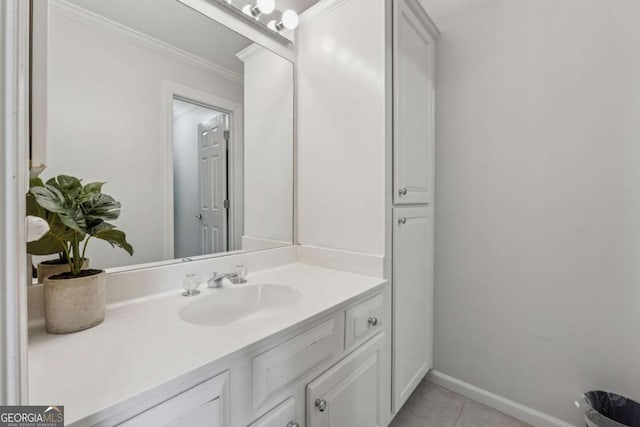 bathroom featuring baseboards, tile patterned floors, vanity, and crown molding